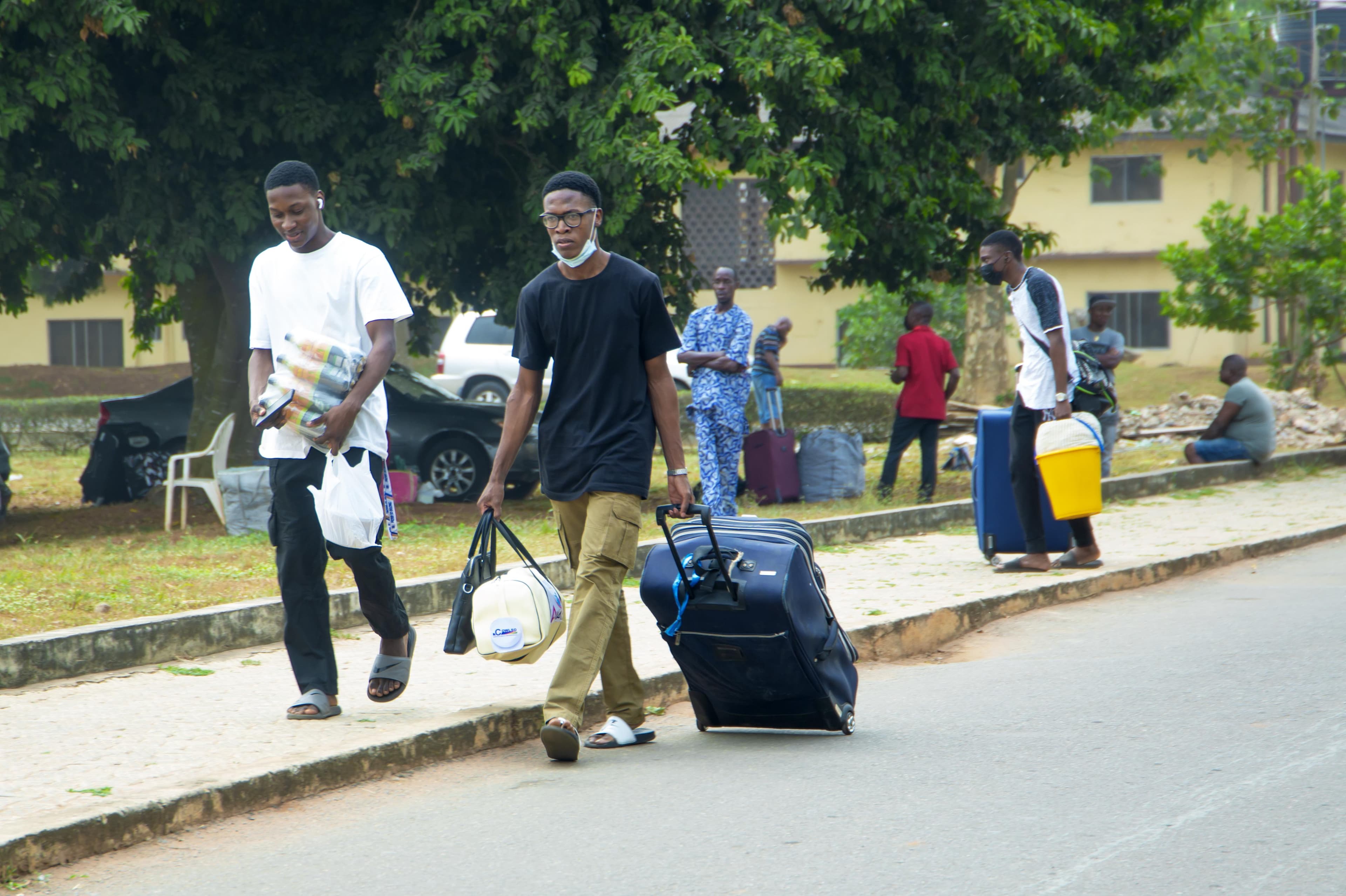 Students boarding a Travel with Hawkins bus